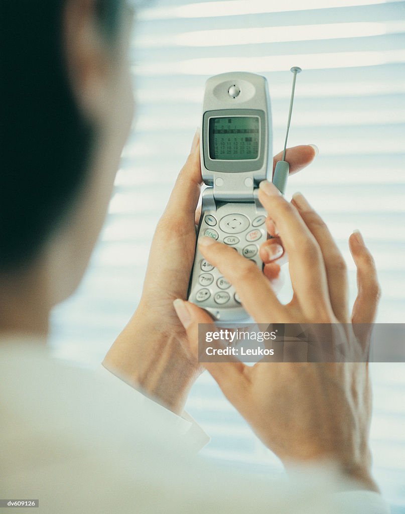 Businesswoman Holding Mobile Phone