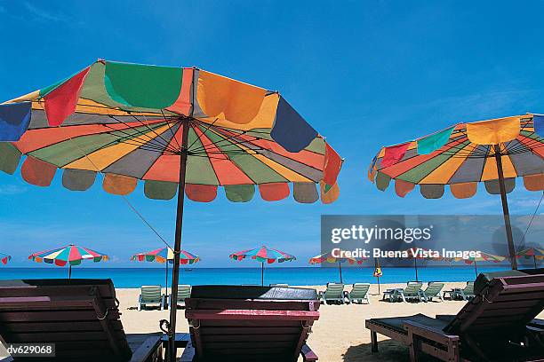 sun loungers and parasols on patong beach, phuket island, thailand - buena vista stock pictures, royalty-free photos & images