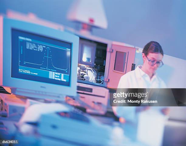 technician reading data from gas spectrometer - monty rakusen stock-fotos und bilder