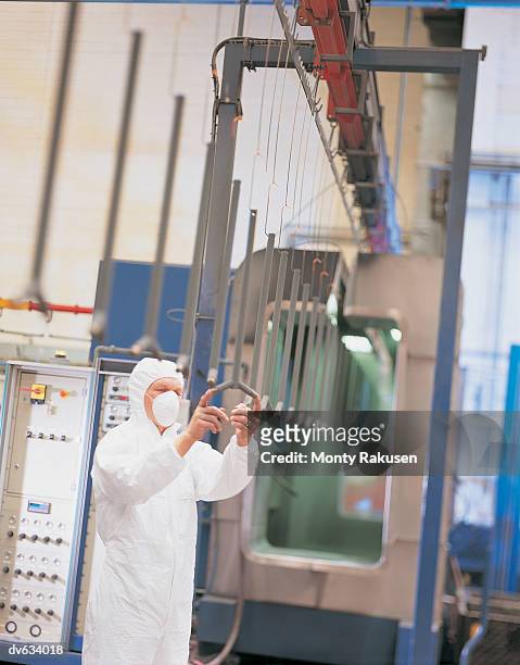 workman checking products before powder coating - monty rakusen stock-fotos und bilder