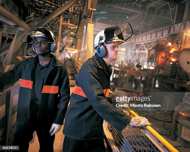 two workers in foundry - monty rakusen stock-fotos und bilder