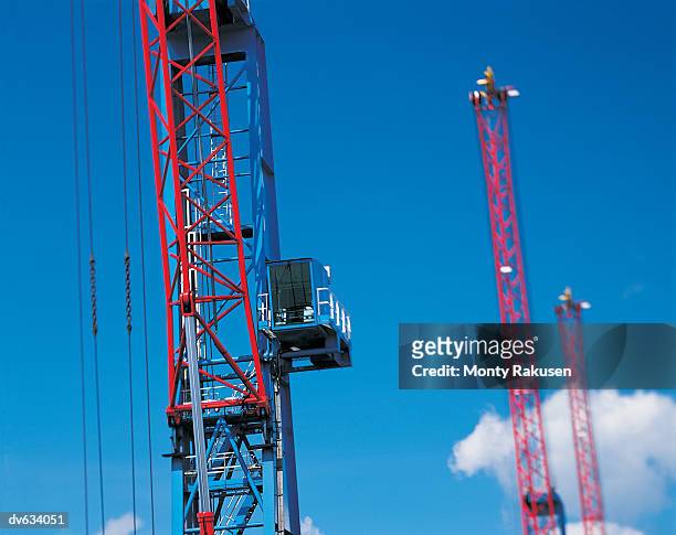 cranes on pier loading cargo onto ships - monty rakusen stock-fotos und bilder