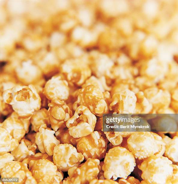 caramel covered popcorn - caramel popcorn stock pictures, royalty-free photos & images