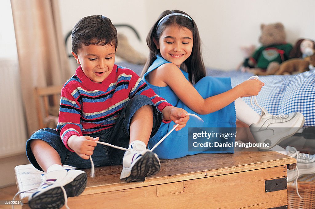 Boy and his Sister Putting Their Shoes on