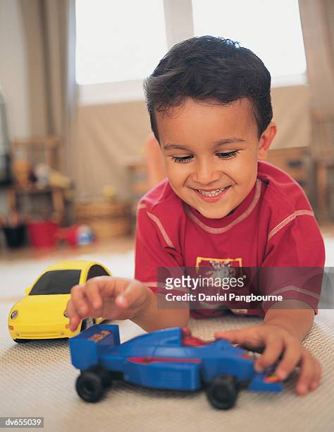 boy playing with toy car - daniel fotografías e imágenes de stock