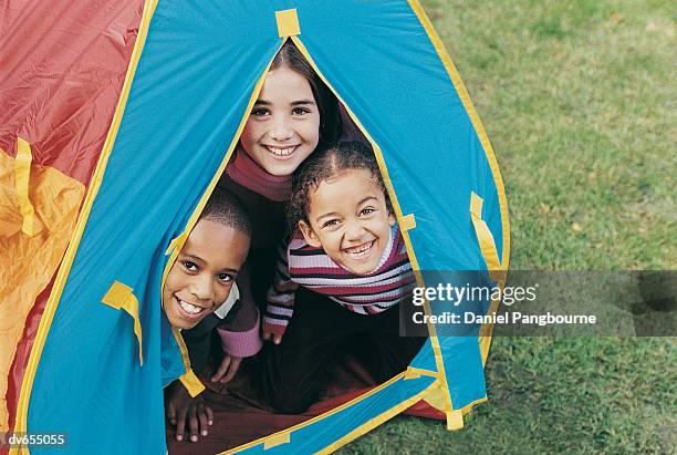 portrait of two girls and a boy in a tent - daniel stock pictures, royalty-free photos & images