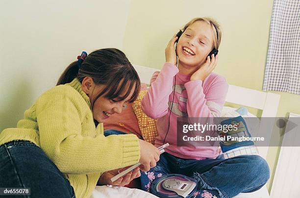 two girls relaxing in a bedroom - daniel fotografías e imágenes de stock