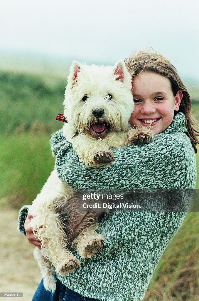 Portrait of a Teenage Girl Holding Her West Highland Terrier