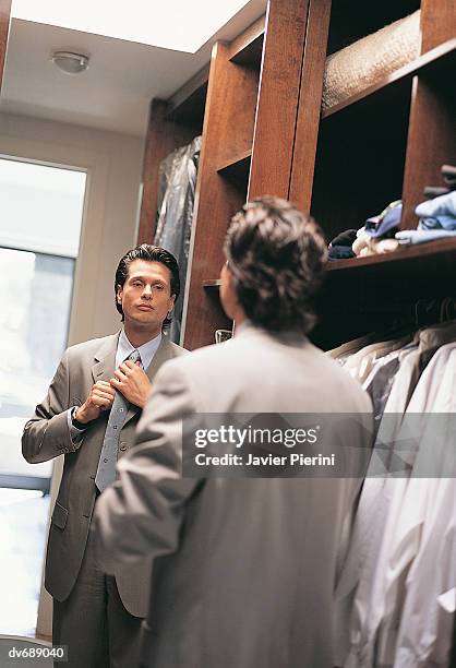 businessman dressing in front of mirror - dressing up ストックフォトと画像