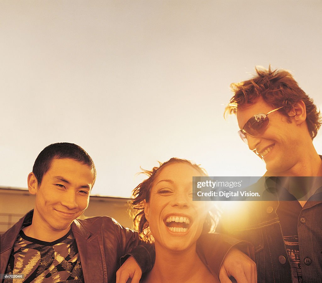 Portrait of Three Friends with the Sun in the Background