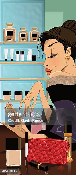 woman drying her nail varnish - gavin stock illustrations
