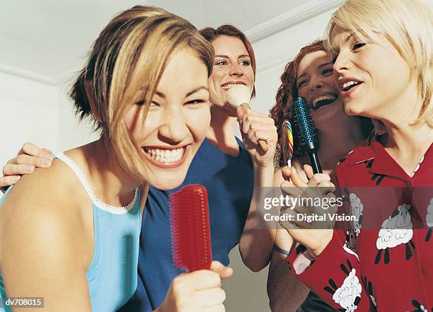 women pretending to sing - girls night in stock pictures, royalty-free photos & images