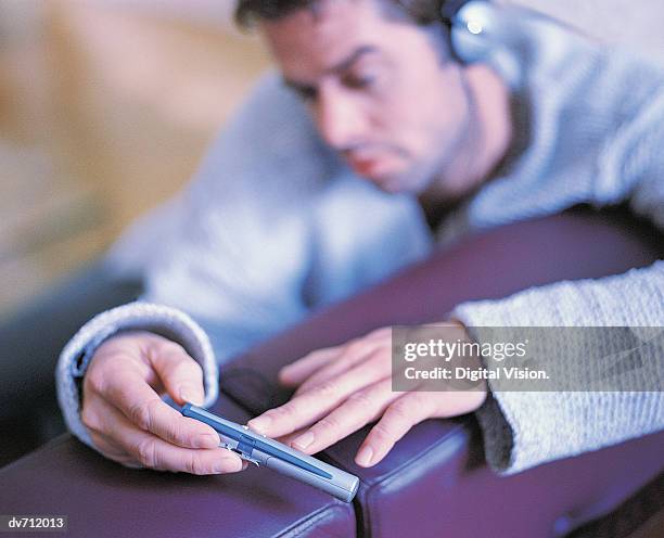 close-up of a man listening to his personal stereo - personal stereo stockfoto's en -beelden