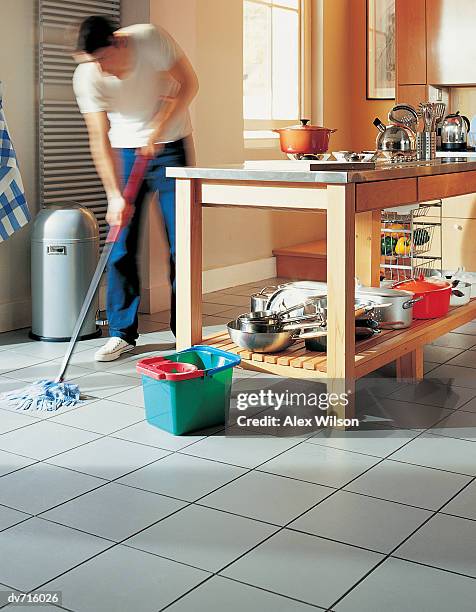 man mopping the kitchen floor - kitchen mop stock pictures, royalty-free photos & images