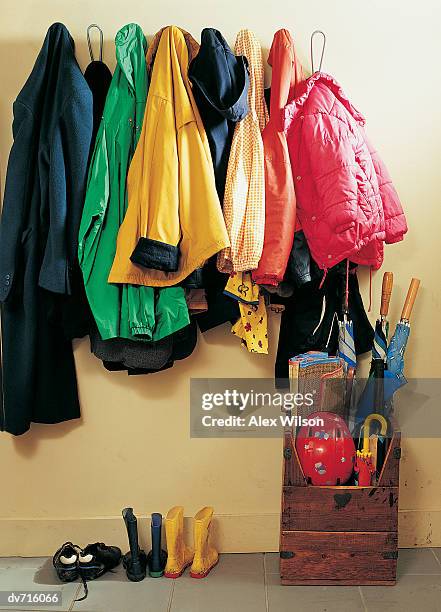 coat rack with shoes and umbrellas underneath - coat rack stock pictures, royalty-free photos & images