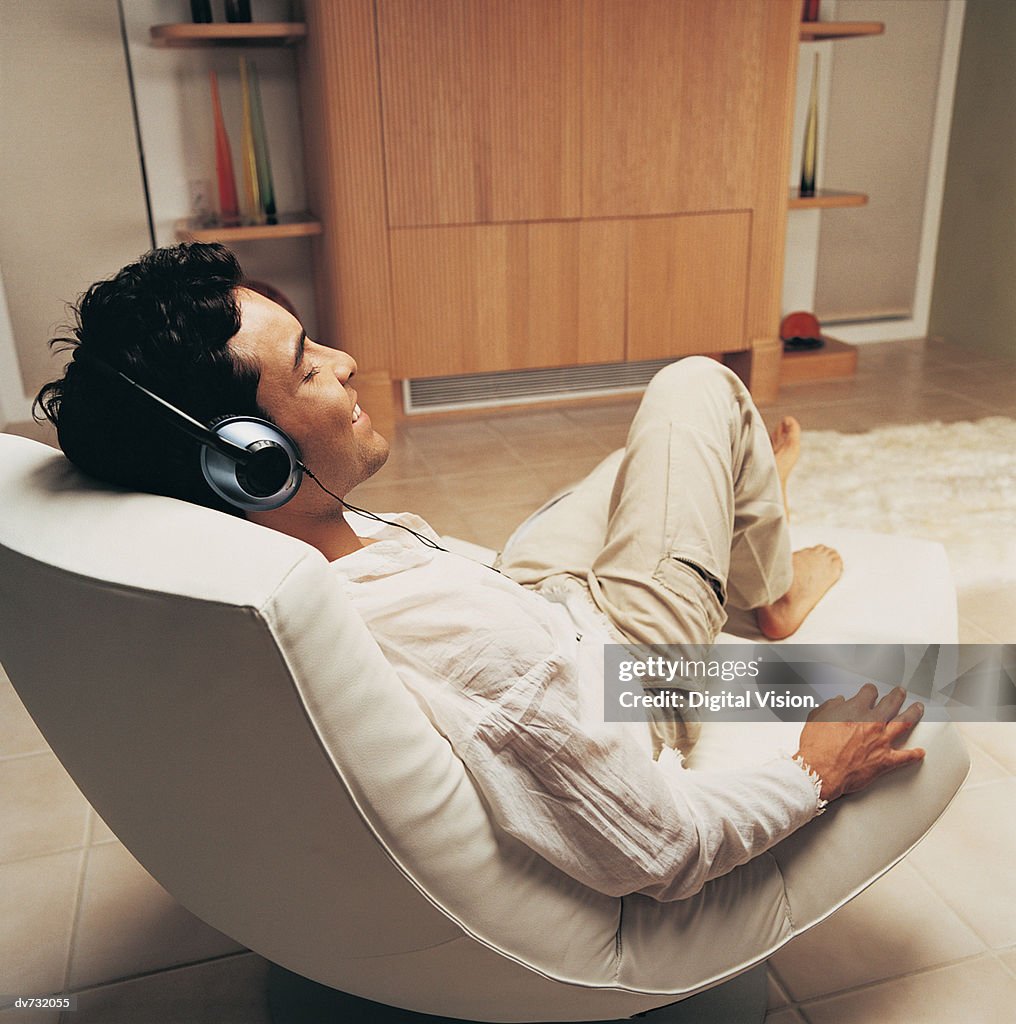 Man Relaxing to Music in His Sitting Room