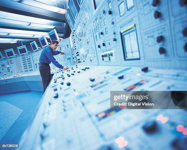 engineer in control room of nuclear power station - nuclear energy worker stock pictures, royalty-free photos & images