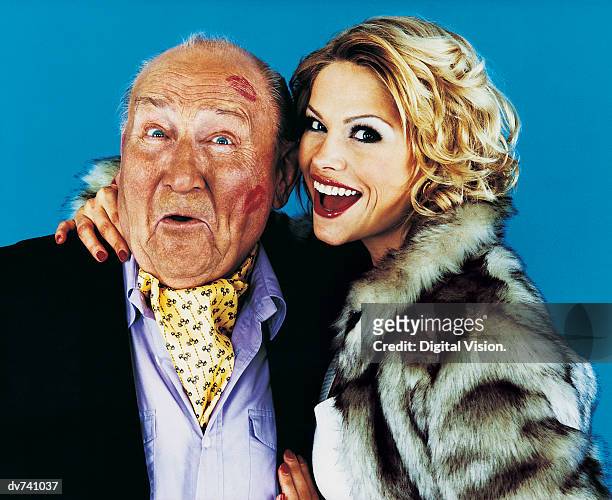 portrait of a woman with her arm around a wealthy senior man - cravat stock pictures, royalty-free photos & images