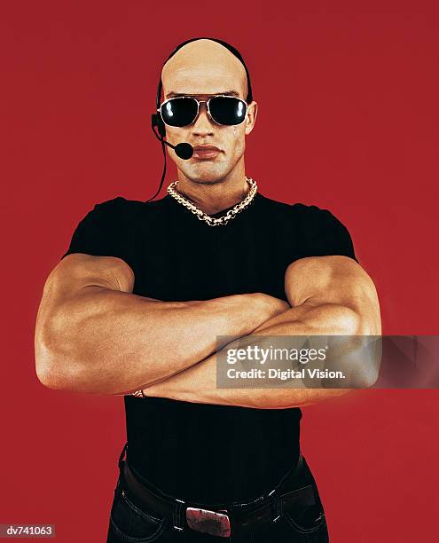 bouncer wearing sunglasses with arms crossed - ドアマン ストックフォトと画像