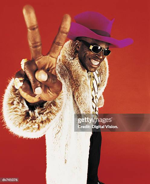 portrait of a man wearing a fur coat, gesturing - stereotypical foto e immagini stock