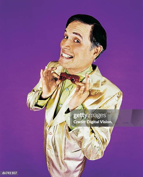 portrait of a compere smiling and adjusting his bow tie - talk show host stock pictures, royalty-free photos & images