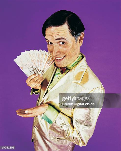 portrait of a tv presenter holding money - presentatore di giochi televisivi foto e immagini stock