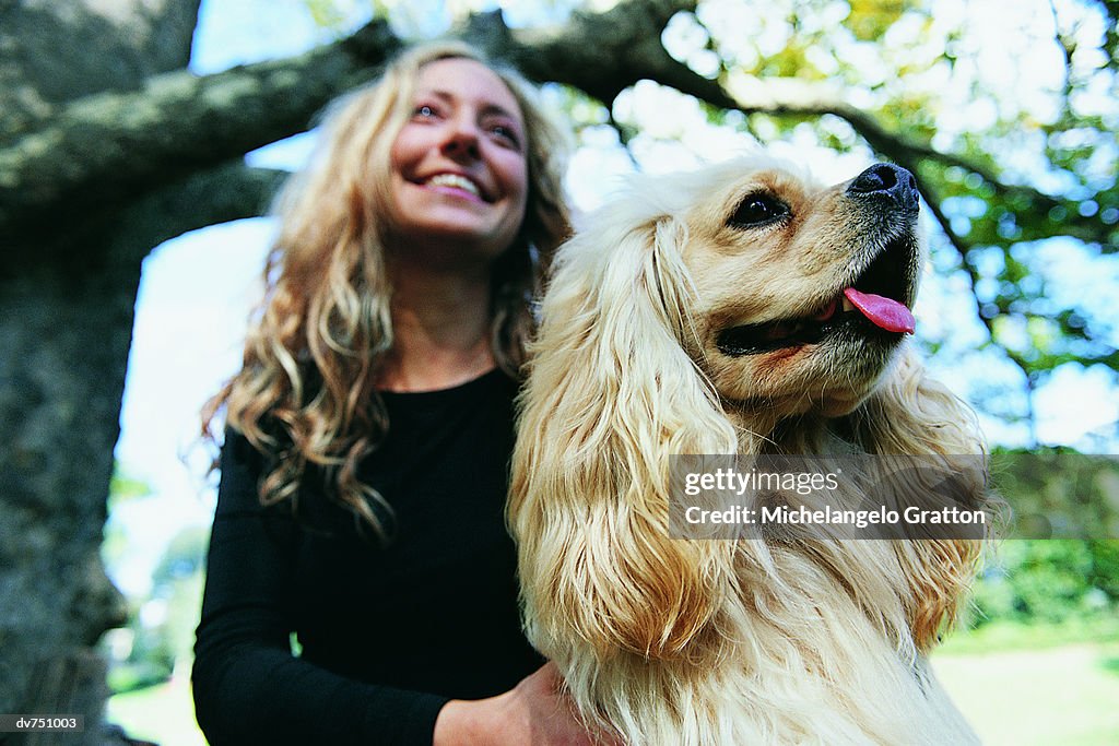 Woman in the Park With Her Cavalier King Charles Spaniel