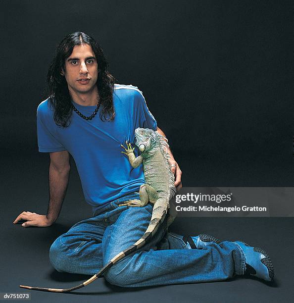portrait of a man with his iguana - exotic pets stock pictures, royalty-free photos & images