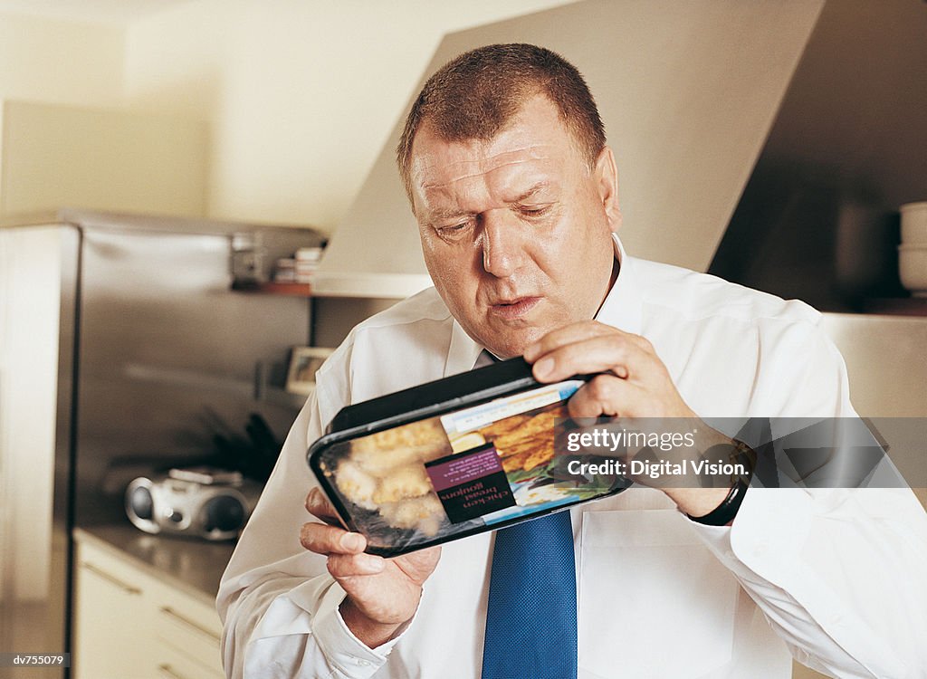 Man Holding Reading Label on Food