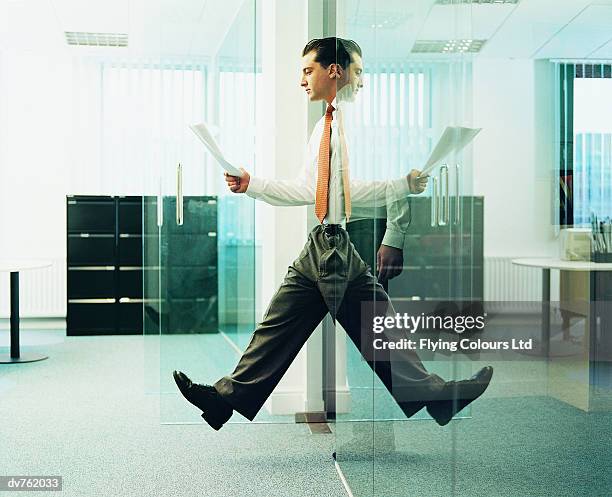 reflection of a businessman walking out of an office - walking into door stock-fotos und bilder