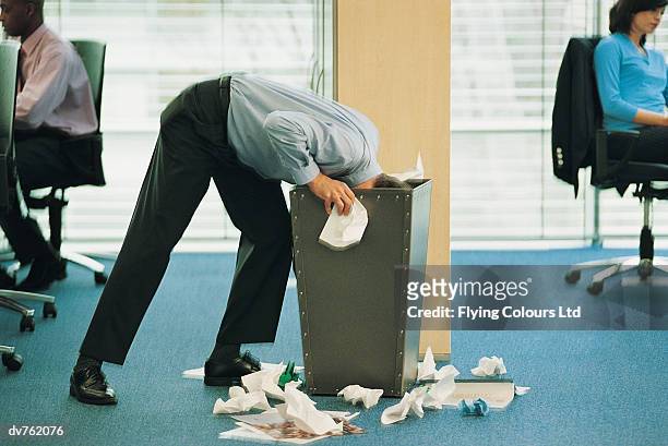 businessman with his head inside an office bin - hiding rubbish stock pictures, royalty-free photos & images