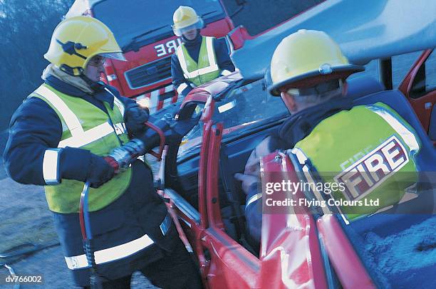 firefighters rescuing an injured man in a mangled car - president trump hosts public safety medal of valor awards at white house stockfoto's en -beelden