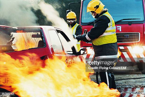 firefighters hosing a burning car - president trump hosts public safety medal of valor awards at white house stockfoto's en -beelden