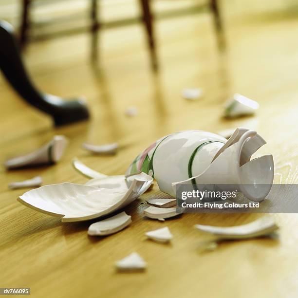 broken vase on a wooden floor - broken vase stock pictures, royalty-free photos & images