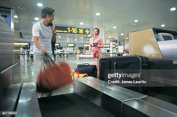 two people standing at an airport check in - check up ストックフォトと画像