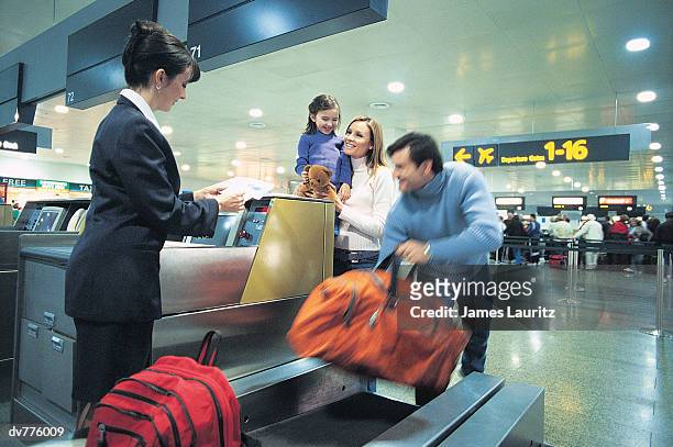 family standing at the airport check in - check up ストックフォトと画像