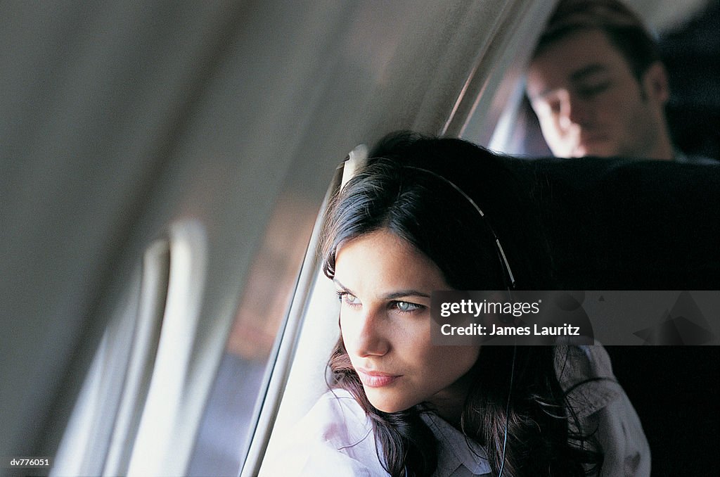 Female Passenger Looking Through an Aeroplane Window