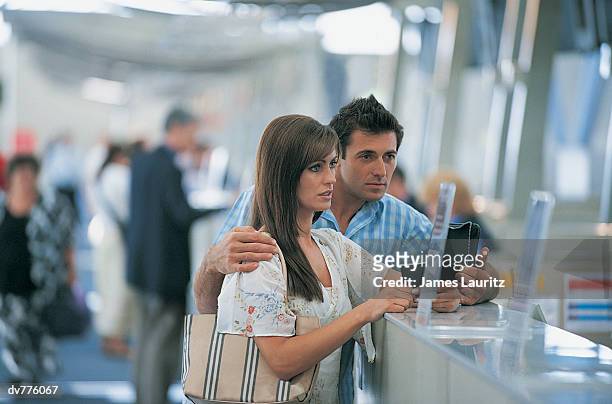late couple standing at the airport check in - check up ストックフォトと画像