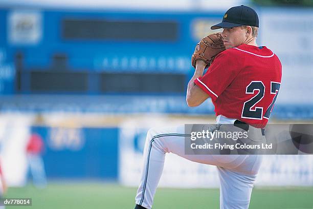 baseball pitcher about to throw the ball - start pitcher stock-fotos und bilder