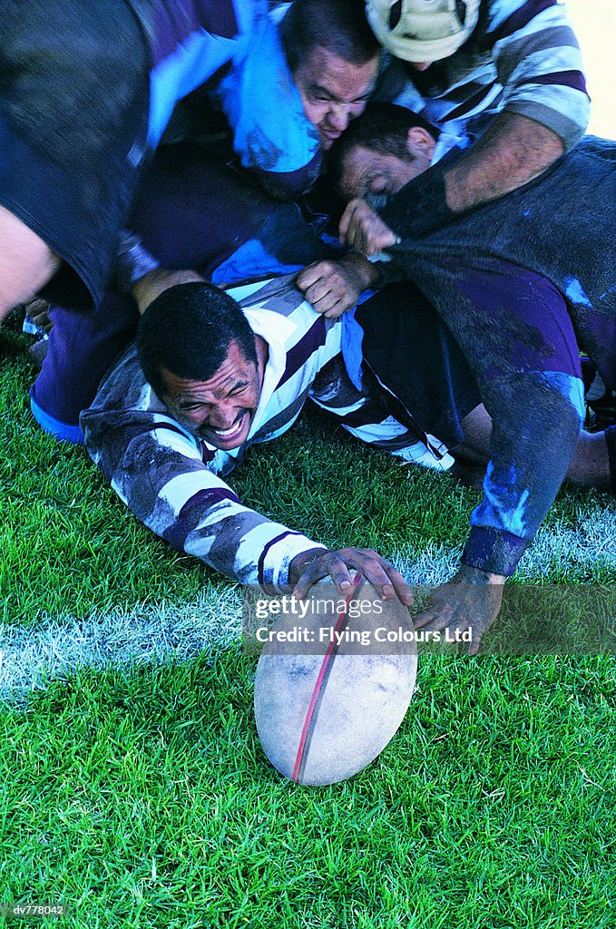 Rugby Union Player Scoring Under a Pile of Players