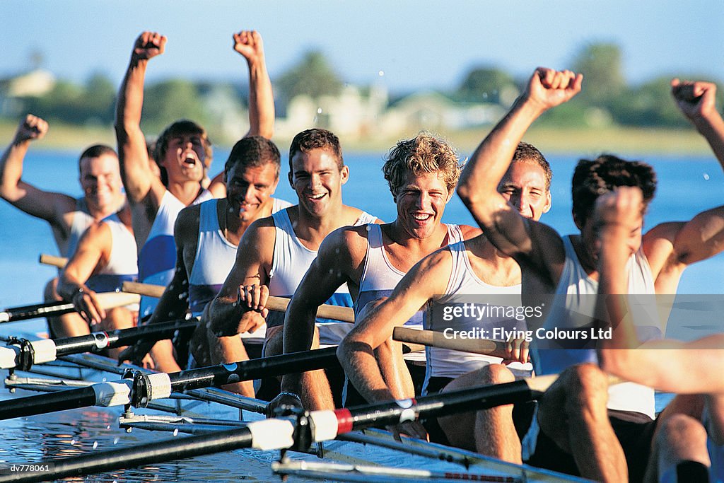 Men Celebrating Success From Sculling on River
