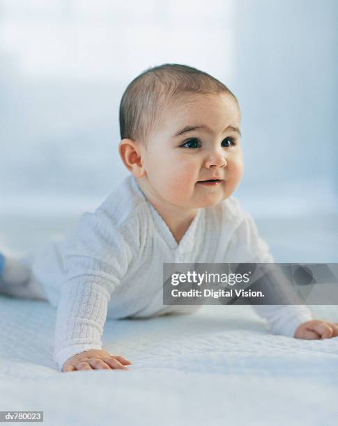 portrait of a toddler on all fours in bed - all stock pictures, royalty-free photos & images