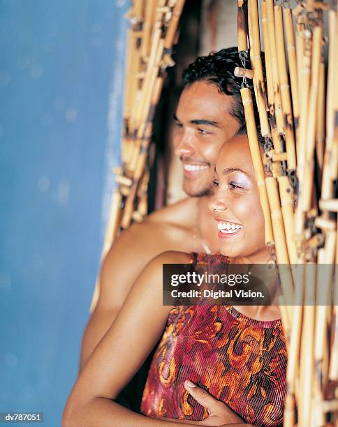 couple embracing by a door - bead curtain stock pictures, royalty-free photos & images