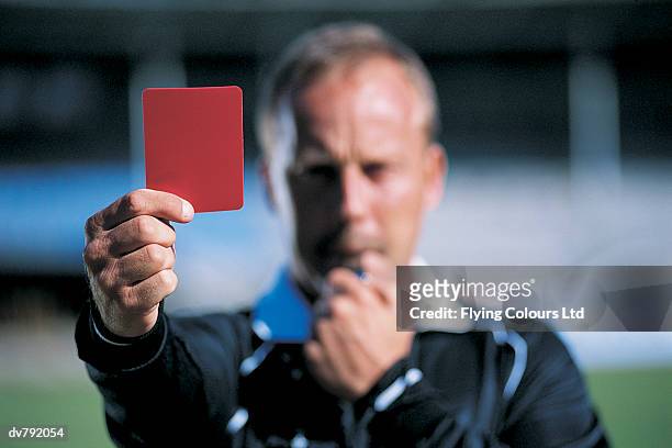 referee holding a red card - referee stockfoto's en -beelden
