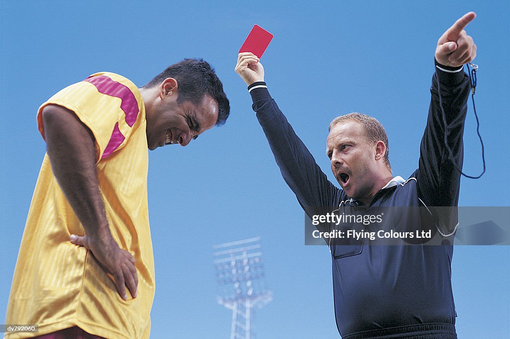 Soccer Player Being Given a Red Card