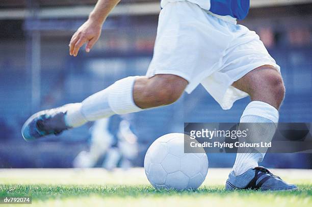 close-up of a footballer kicking a ball - ltd stock pictures, royalty-free photos & images