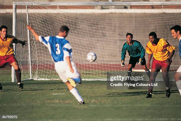 soccer player kicking at goal - ltd stock pictures, royalty-free photos & images