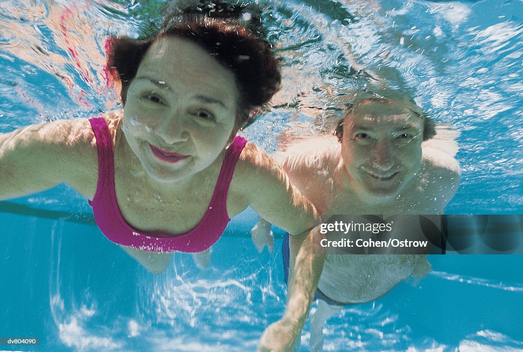 Portrait of a Mature Couple Swimming Underwater