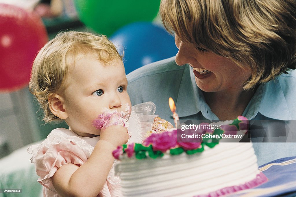 Mother Showing Her Baby a Birthday Cake