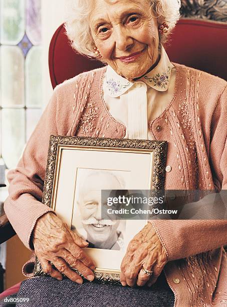 portrait of an elderly widow holding a photograph of her dead husband - handlebar moustache stock pictures, royalty-free photos & images